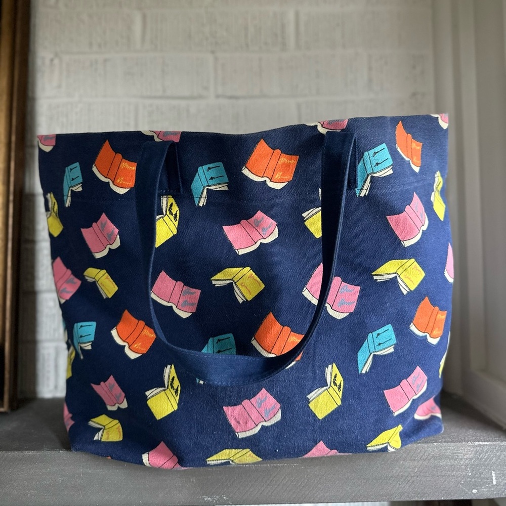 Adorable navy book printed tote 14x20, like new.  Pocket inside. Book lo…